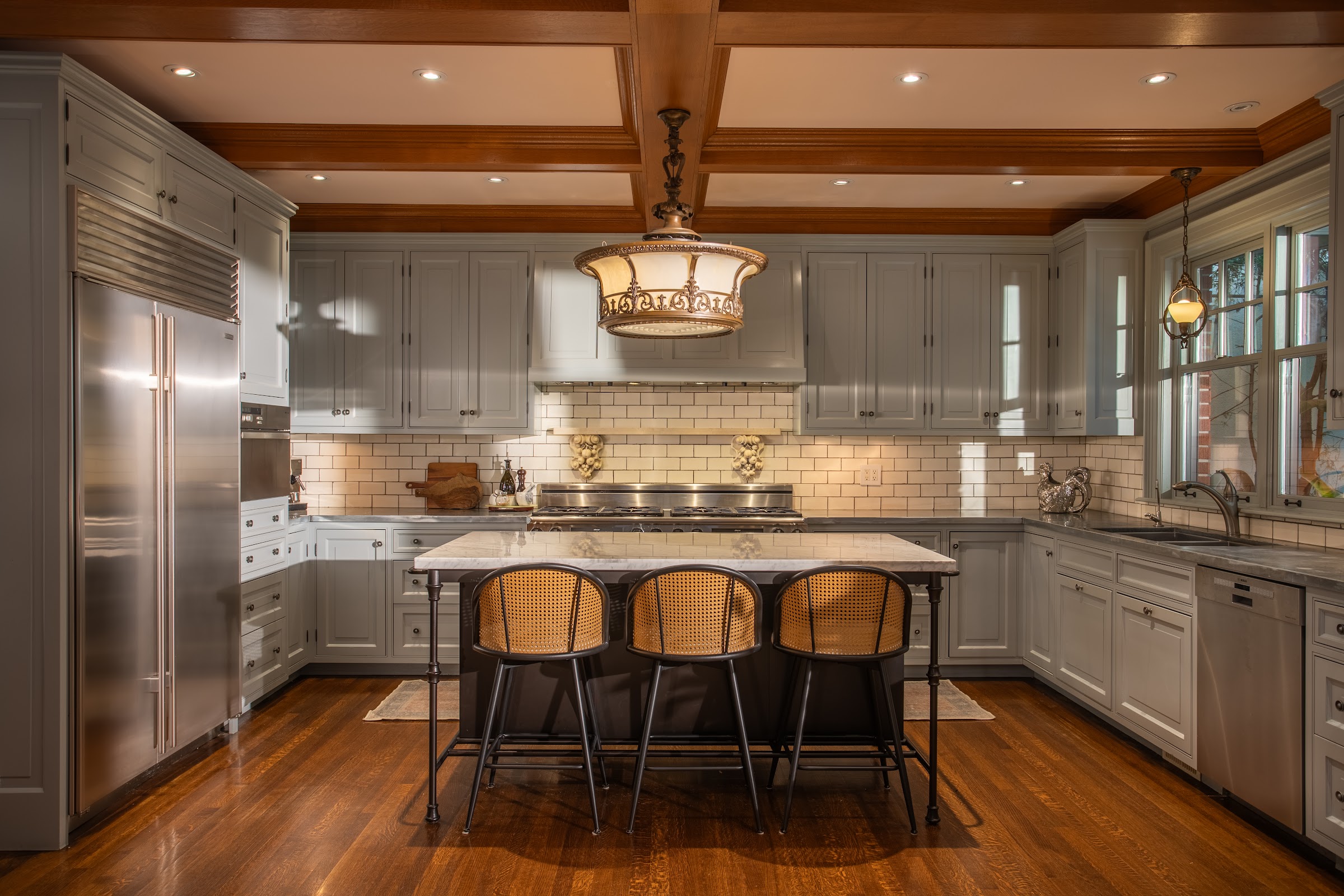 Chef's kitchen with an oversized marble island and professional appliances